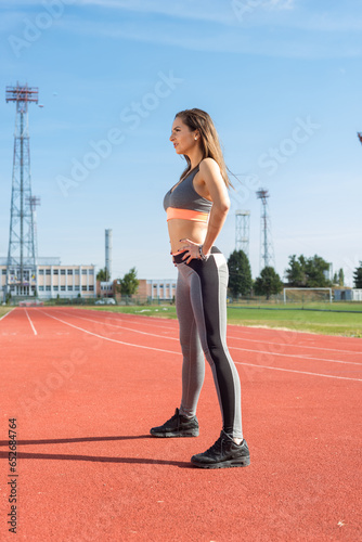 Obraz na płótnie Beautiful woman training on the tracks on a sunny morning w salonie