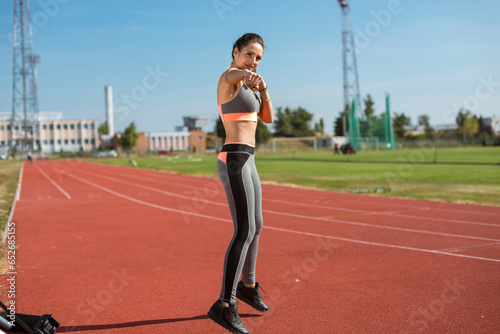Obraz na płótnie Beautiful woman training on the tracks on a sunny morning w salonie