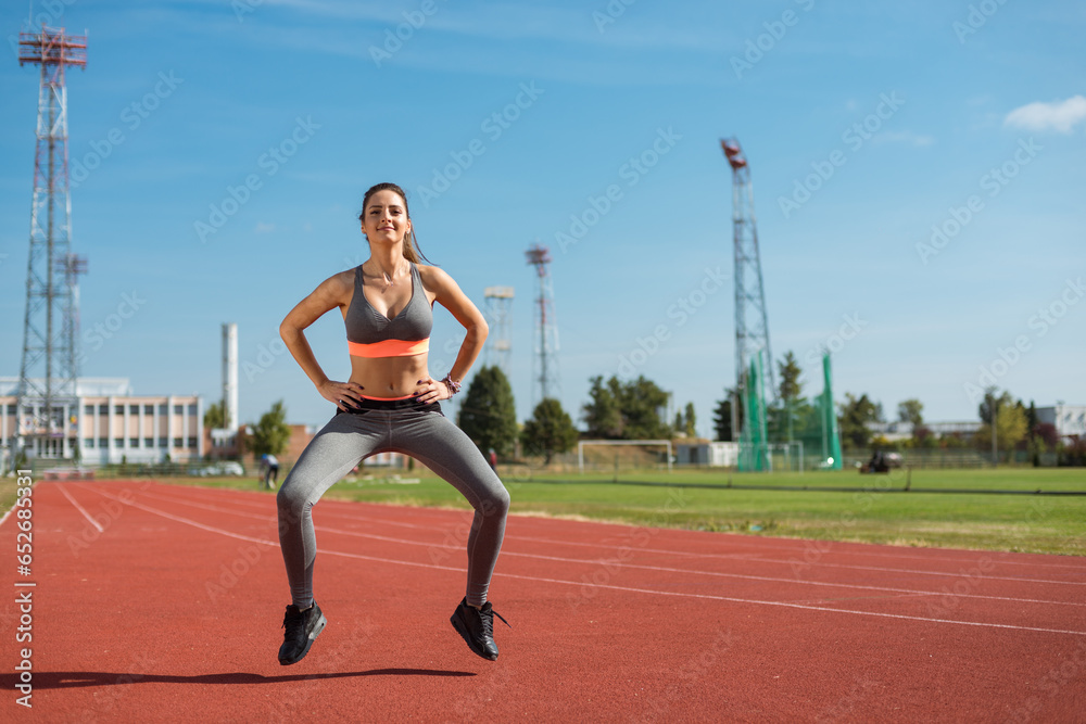 Beautiful woman training on the tracks on a sunny morning
