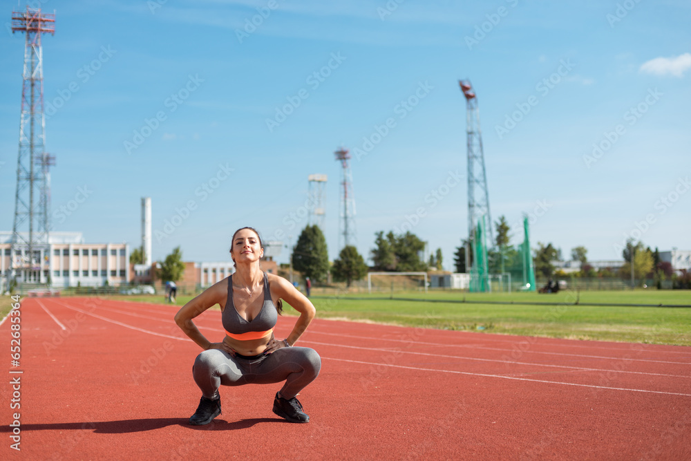 Beautiful woman training on the tracks on a sunny morning