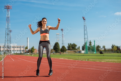Obraz na płótnie Beautiful woman training on the tracks on a sunny morning w salonie