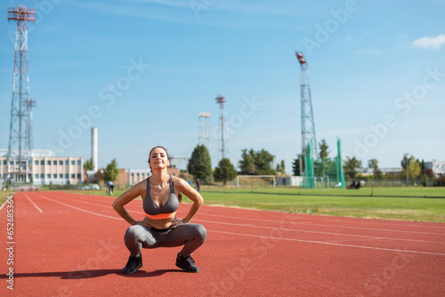 Obraz na płótnie Beautiful woman training on the tracks on a sunny morning w salonie