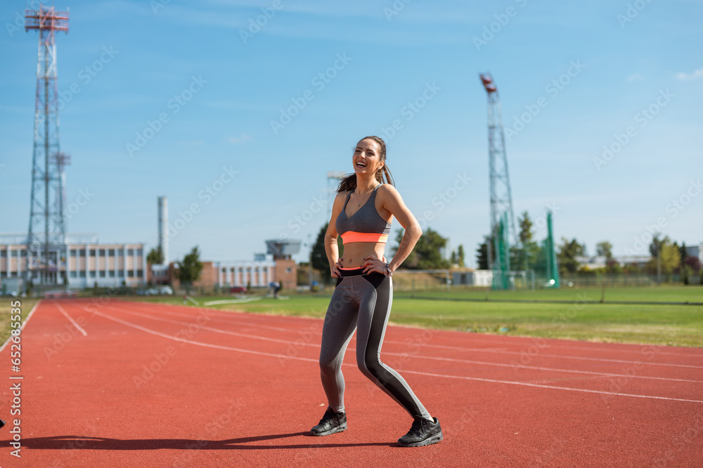 Beautiful woman training on the tracks on a sunny morning