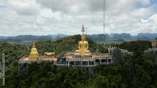 Aerial View Tiger Cave Temple, Buddha on the Top Mountain with Blue Sky of Wat Tham Seua, Krabi, Thailand. Aerial View 4K. photo