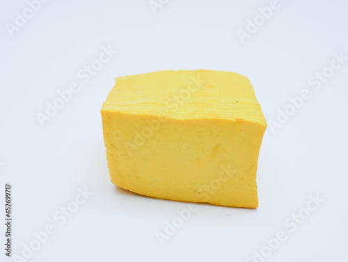 raw yellow tofu isolated on white