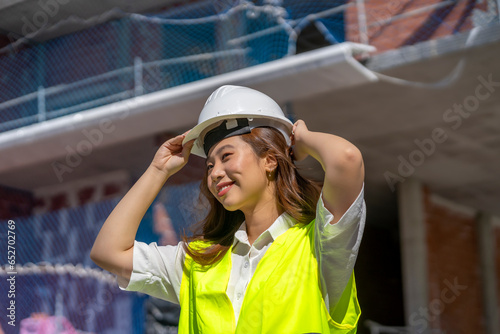 female architect putting on her safety helmet