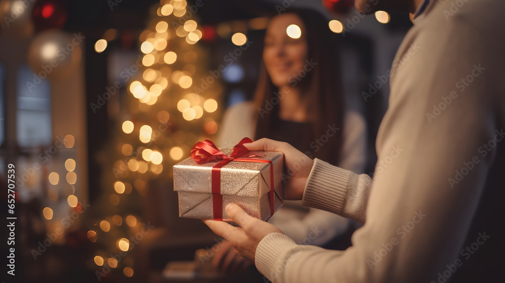 couple in love giving each other gifts at christmas - obrazy, fototapety, plakaty 
