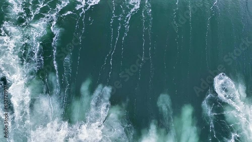 slow motion drone view of huge ocean wave crashing. Aerial shot of breaking surf with foam in Indian Ocean. Powerful sea wave breaking, Flying above barreling ocean wave
