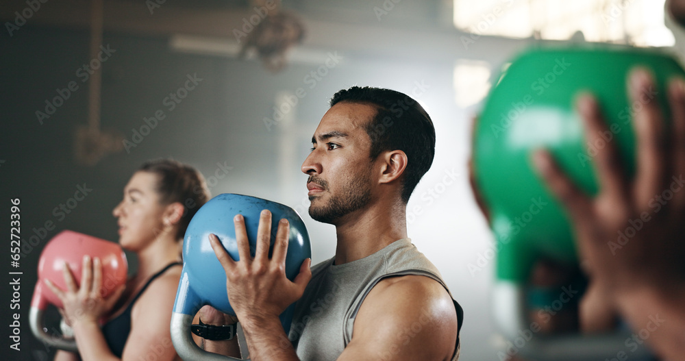 Gym, group fitness and kettlebell squat exercise for power, sports challenge and muscle. Serious asian man, bodybuilder and heavy weights for training in health club, workout class and strong friends - obrazy, fototapety, plakaty 