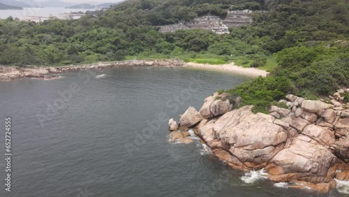 Aerial Rising Shot From Rocky Coastline To Reveal Island View Of Cheung Chau In Hong Kong photo