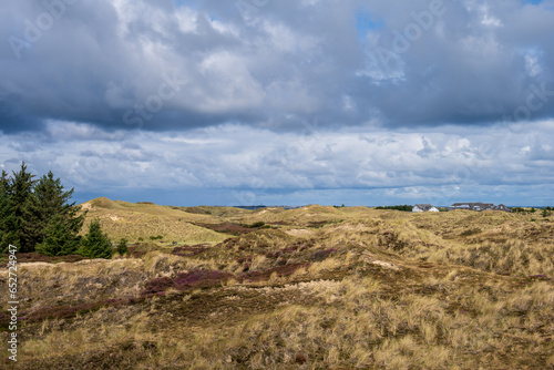 Dramatische Wolken im Dünenbereich der Nordseeinsel Amrum der Blick geht hinüber zur Nachbarinsel Sylt mit dem Leuchtturm von Hörnum