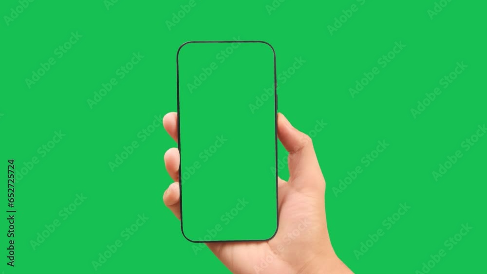 Hands holding smartphone with green screen in green background vertical green Hands holding smartphone with green screen in green background vertical green
