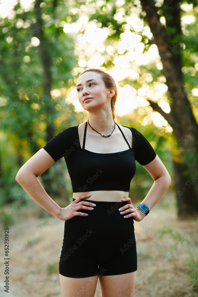 young sports woman in forest park. Fitness girl at sunset on nature, health and sport concept young sports woman in forest park. Fitness girl at sunset on nature, health and sport concept