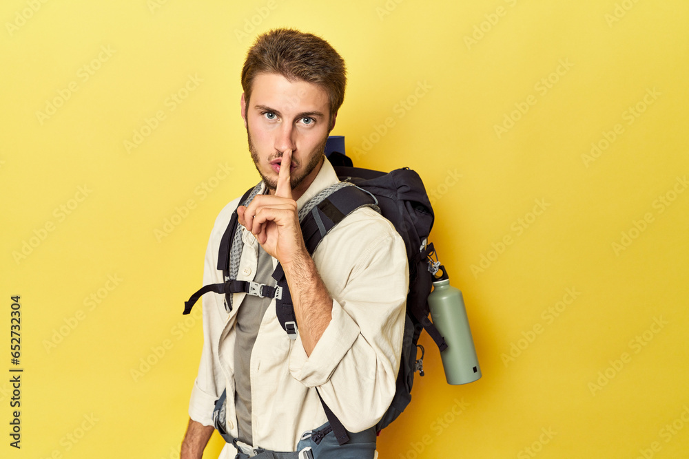 Fototapeta premium Traveler with mountain gear and yoga mat keeping a secret or asking for silence.