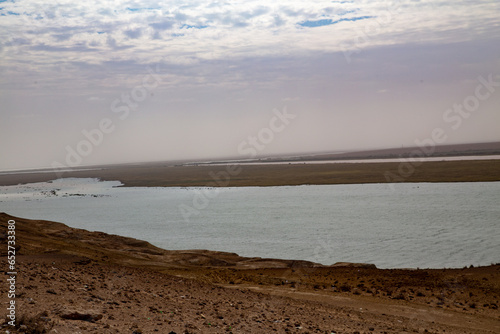 Photograph of a lake in the deserts of Central Asia becoming unfit for drinking due to shrinking lakes and increasing salinity. photo