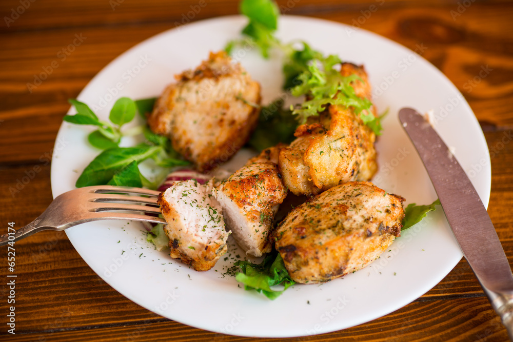 Fried pieces of chicken fillet breaded with spices and herbs in a plate . Fried pieces of chicken fillet breaded with spices and herbs in a plate .