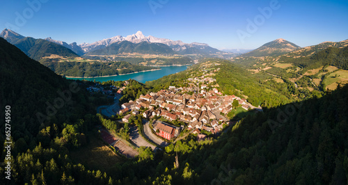 Aerial view of the village of Corps with Sautet Lake. In the distance, the higest point in Devoluy mountain range, the Obiou peak. Isere, Alps, France photo
