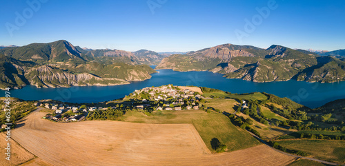 Panoramic aerial view of Serre-Poncon lake with Le Sauze-du-Lac village. Durance Valley in summer. Hautes-Alpes (Alps), France photo