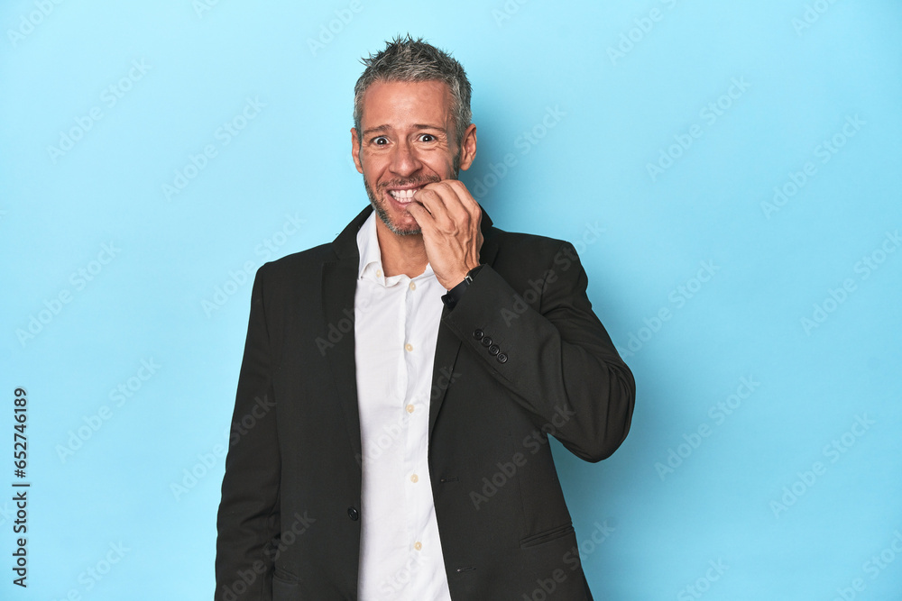 Caucasian businessman, middle-aged on blue background Caucasian businessman, middle-aged on blue background
