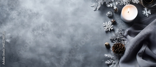Christmas cozy composition with candles, snowflakes, decoration on grey concrete texture background. Top view. Flat lay. Still life. New year banner, mockup. Generative ai.