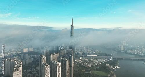 Aerial view of the top of the tallest skyscraper in Ho Chi Minh City on a foggy winter day. Cityscape in Ho Chi Minh City, Vietnam