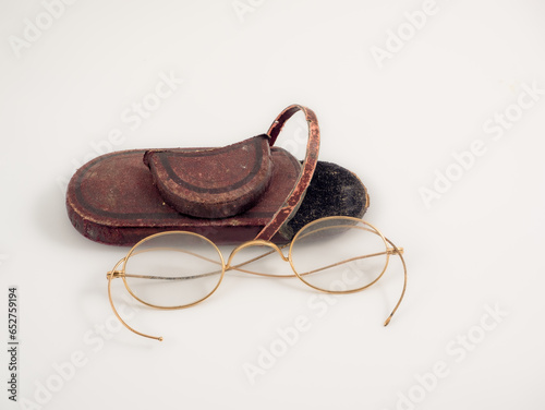 rare original antique brass wire spectacles glasses in felt lined red case isolated on a white background