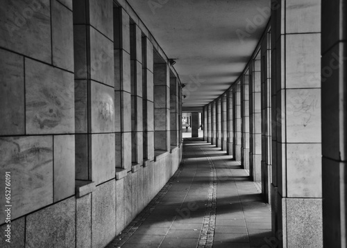 Grayscale shot of a path found outside of a building with a beautifully decorated exterior