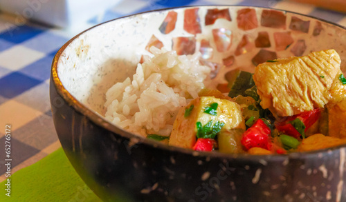 Photography Oriental chicken stew with rice served in a rustic bowl