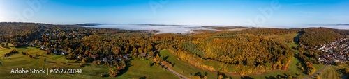 Bird's eye view of the forests near Engenhahn/Germany in autumn with morning fog in the background photo