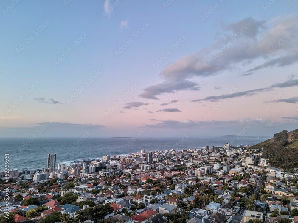Aerial shot of Cape town with its dense buildings on the coastline of the sea Aerial shot of Cape town with its dense buildings on the coastline of the sea