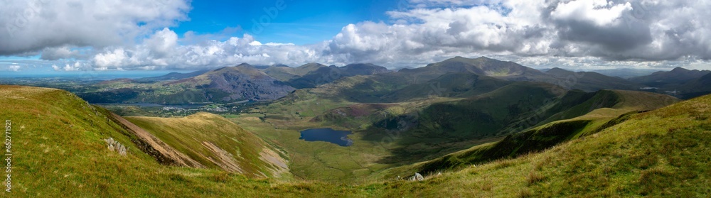 Fototapeta premium Panoramic view of beautiful mountains and green hills on a sunny summer day