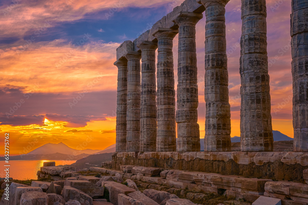 Sunset sky and ancient ruins of temple of Poseidon, Sounion, Greece