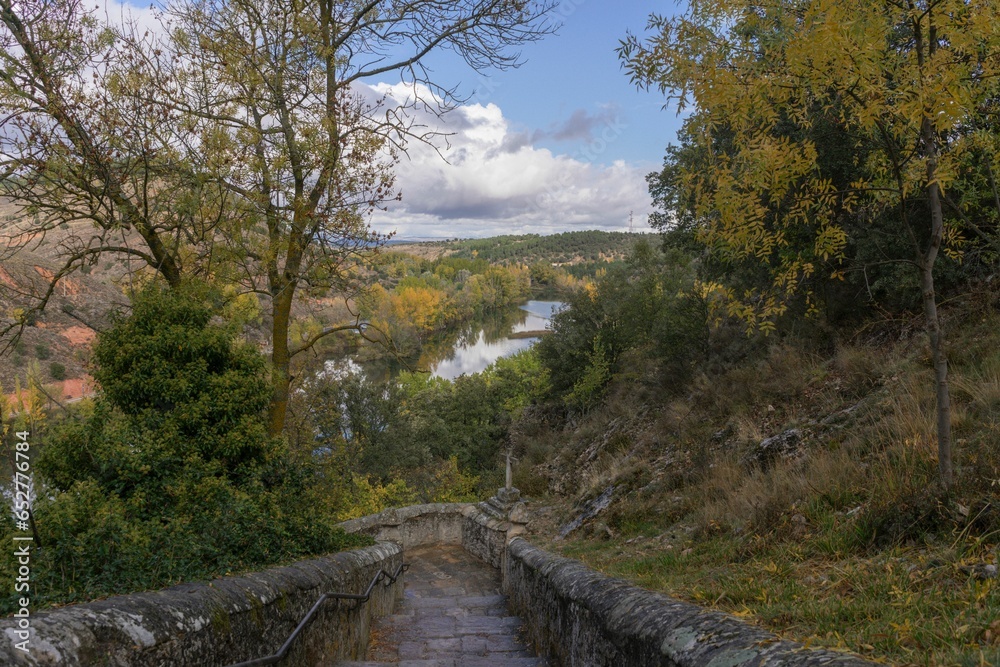 Stone stairs of the hermitage of San Saturio in Soria on an autumn day surrounded by trees