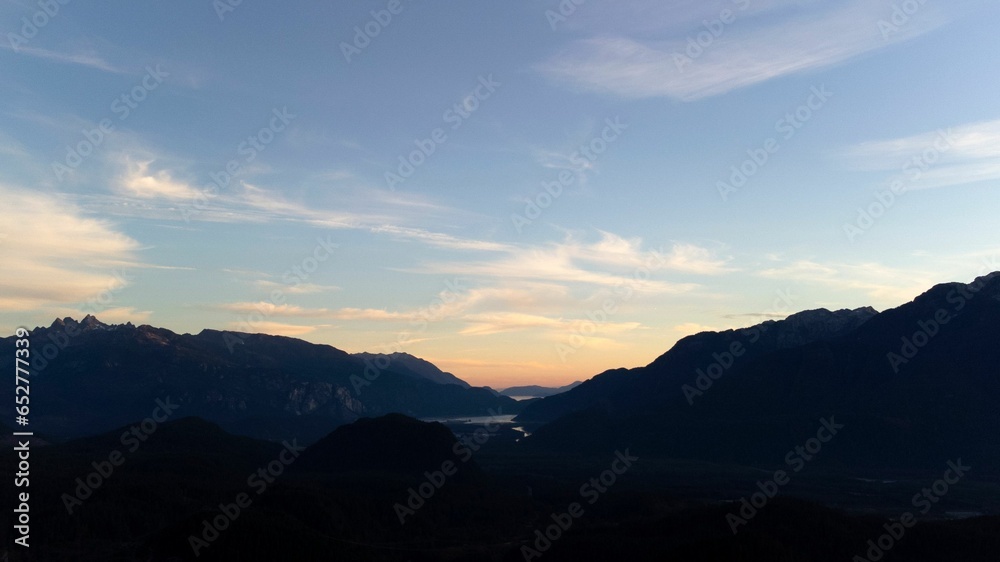 River between mountains with a cloudy blue sky in the background, Squamish, British Columbia, Canada