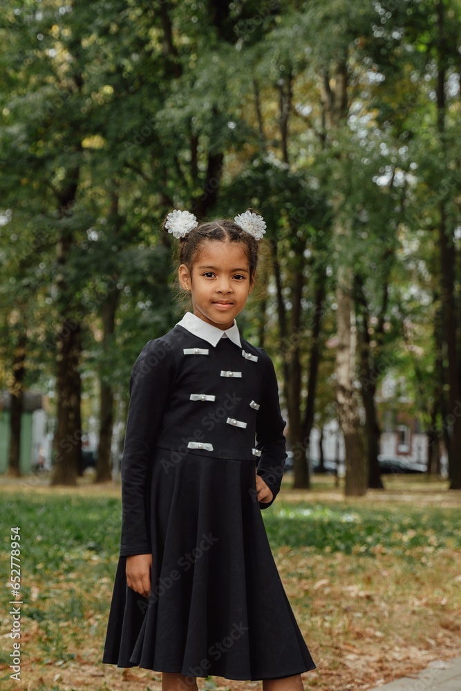 Vertical portrait of a girl in a park