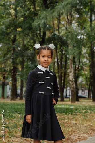 Vertical portrait of a girl in a park