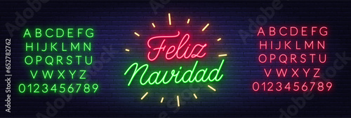 Feliz Navidad neon lettering on brick wall background.