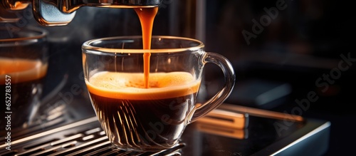 Close up shot of a small espresso cup on the coffee machine symbolizing hospitality and a hot drink