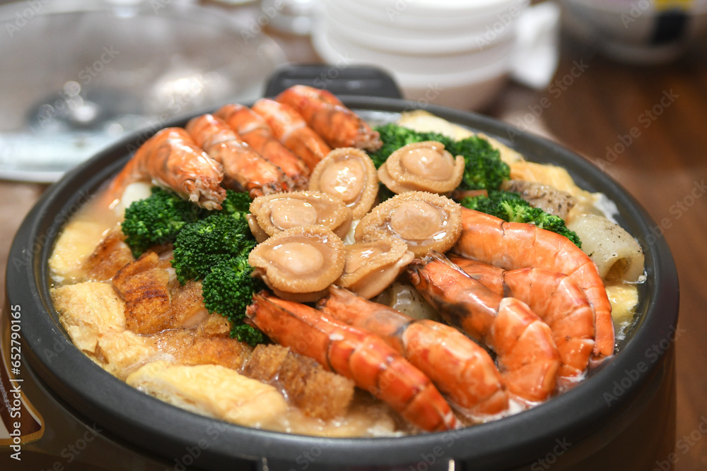 Poon Choi or Pen Cai, traditional Cantonese dish comprised of a number of ingredients Poon Choi or Pen Cai, traditional Cantonese dish comprised of a number of ingredients