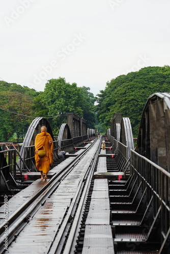 Monk crossing the River Kwai Bridge 
