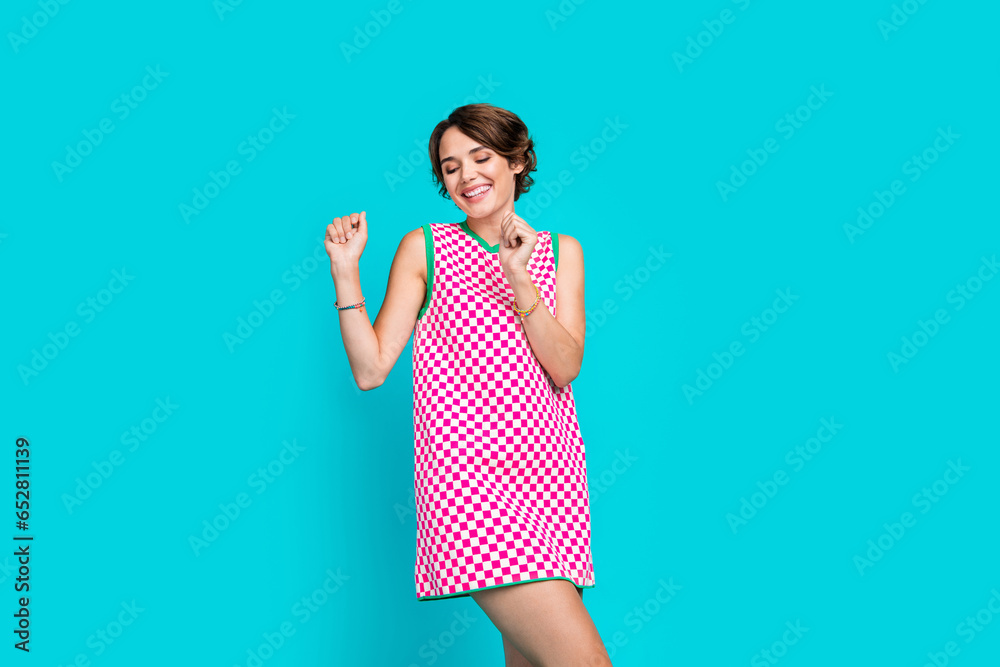 Photo of gorgeous joyful girl wear stylish plaid clothes sarafan celebrating festive event occasion isolated on cyan color background Photo of gorgeous joyful girl wear stylish plaid clothes sarafan celebrating festive event occasion isolated on cyan color background