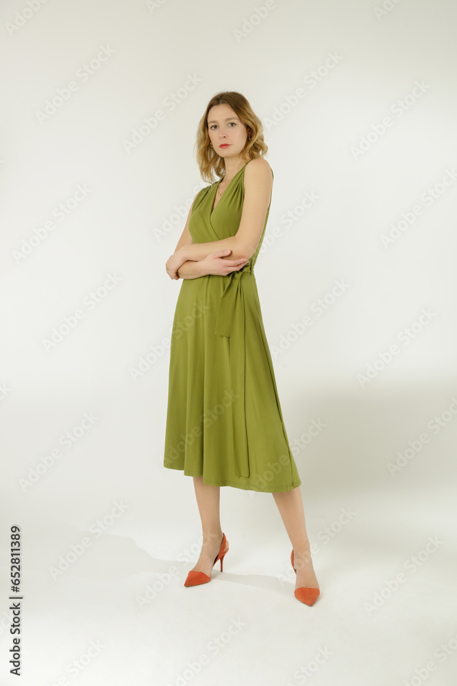 Serie of studio photos of young female model in green viscose wrap dress.
Serie of studio photos of young female model in green viscose wrap dress.