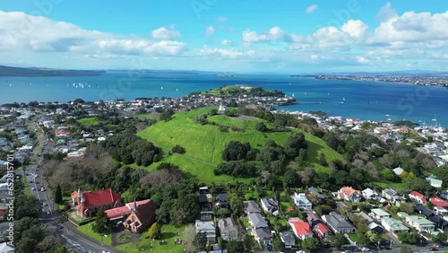 Auckland, New Zealand: Aerial drone footage of the Mount Victoria in Davenport residential district with the Summit hill in the background in New Zealand largest city.  photo