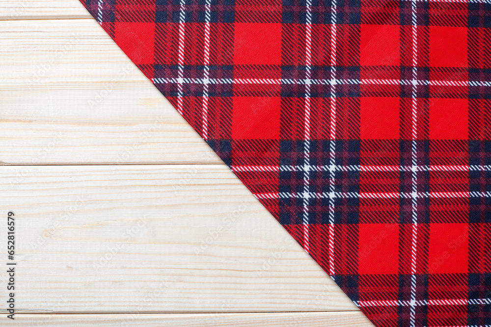 Obraz premium Red Checkered napkin on wooden background