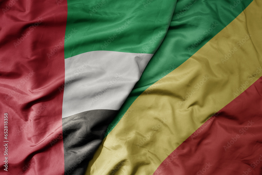big waving realistic national colorful flag of united arab emirates and national flag of republic of the congo .