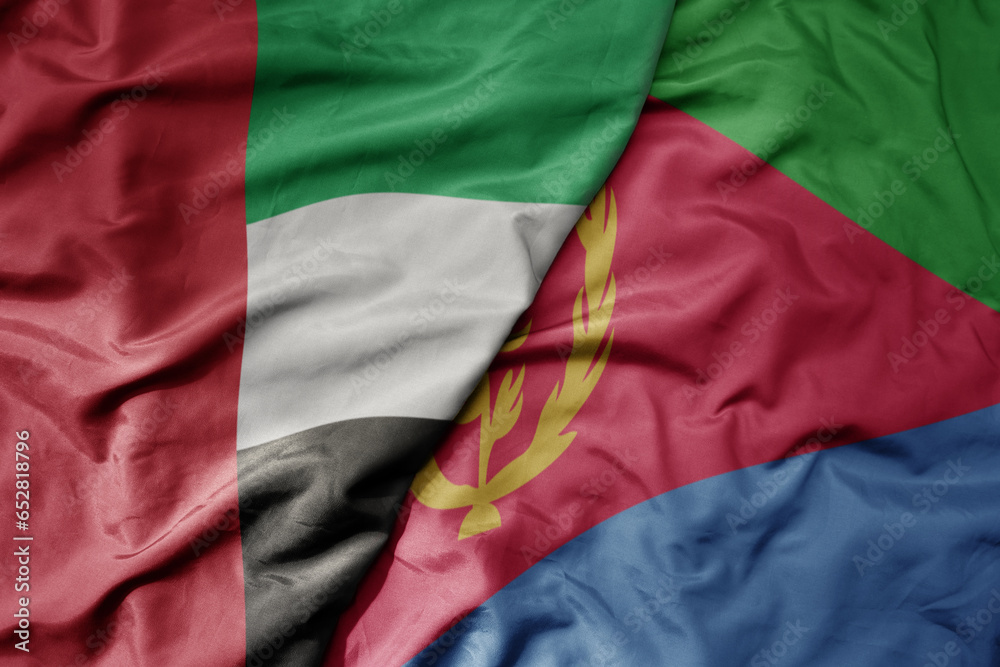 big waving realistic national colorful flag of united arab emirates and national flag of eritrea .