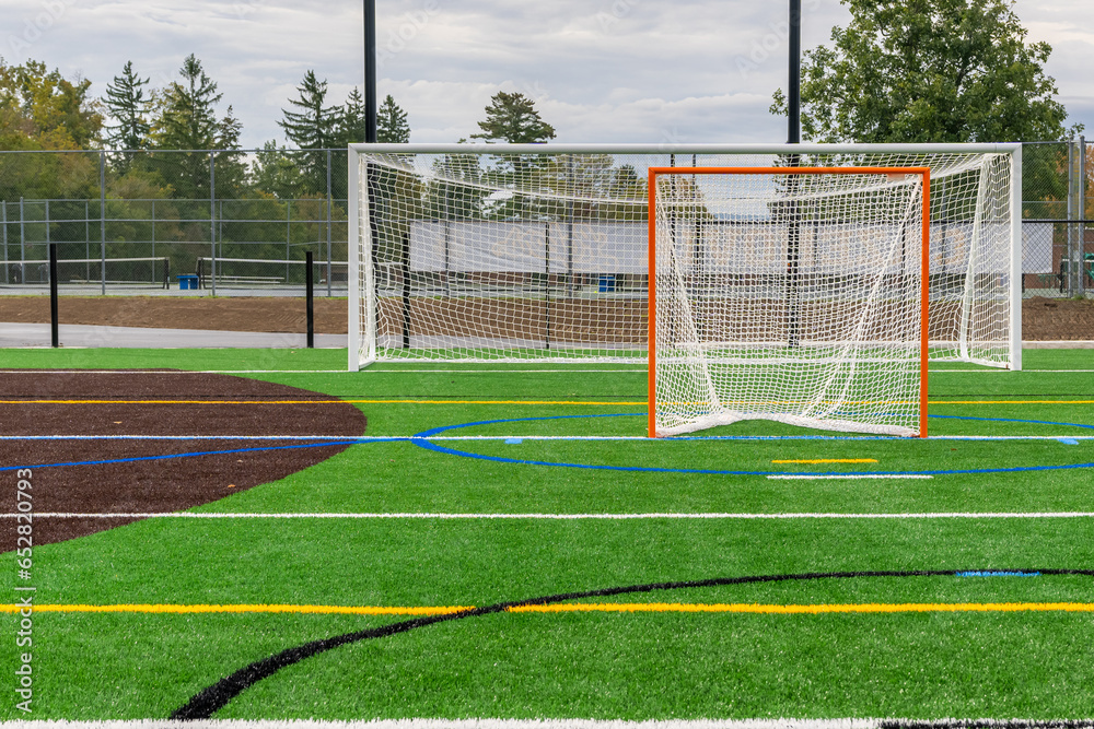 Fototapeta premium Photo of a lacrosse goal on a empty green synthetic turf field. 