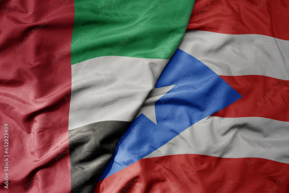 big waving realistic national colorful flag of united arab emirates and national flag of puerto rico .