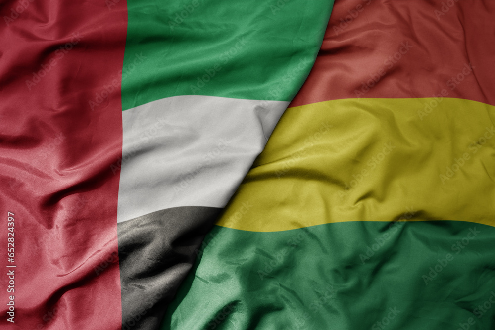big waving realistic national colorful flag of united arab emirates and national flag of bolivia .
