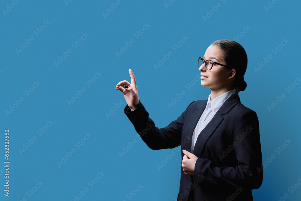 Female student touching on virtual screen, blue copy space background Female student touching on virtual screen, blue copy space background